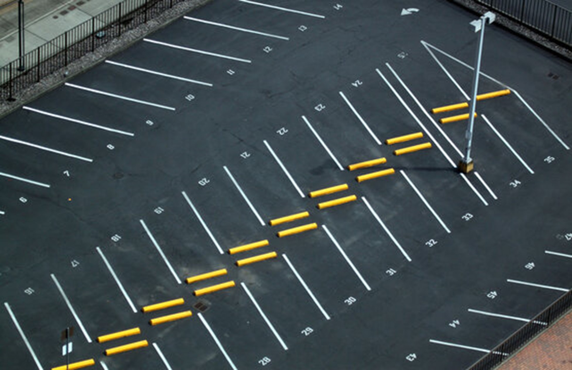 An Air view shot of a perfectly striped parking lot