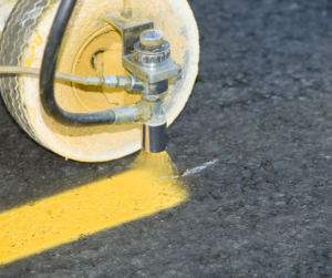 A machine striping a parking lot with durable paint